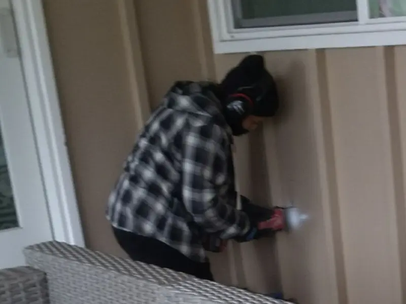 Professional electrician installing an exterior outlet in Lincoln City